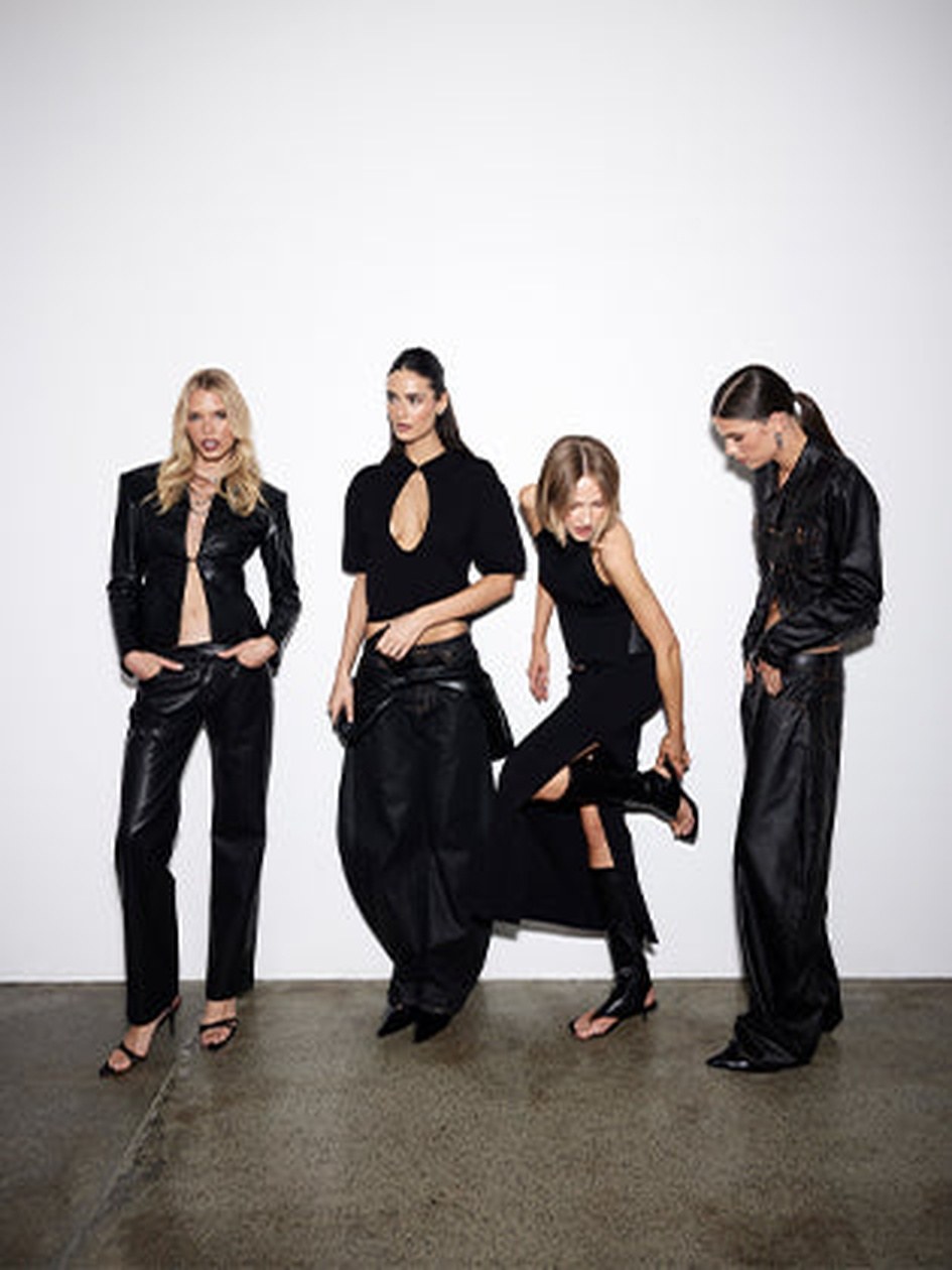LIONESS models in dark separates posing together in a studio
