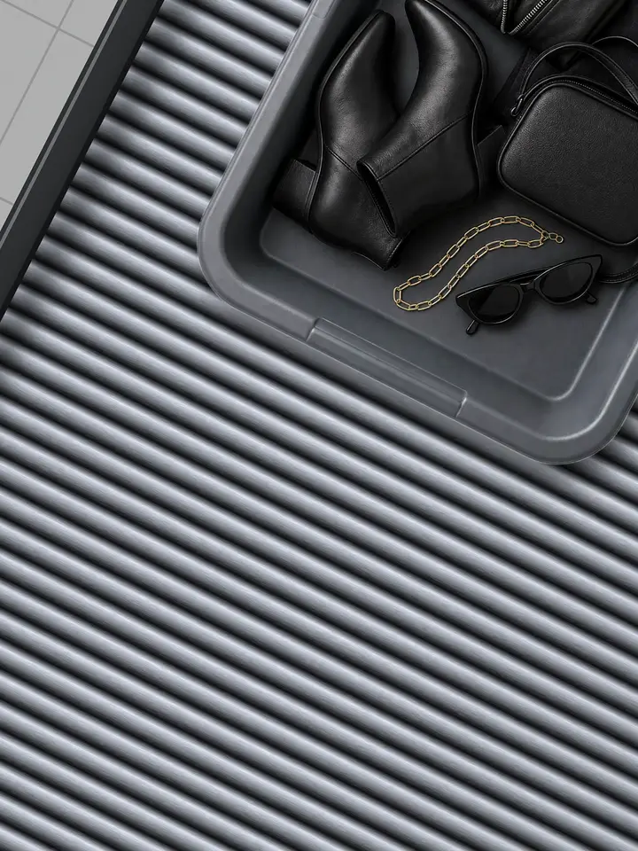 Phia ad: packed airport security trays for a New York weekend, London and Tokyo slide down a conveyor. Let Phia do the packing for you. Install your free digital closet today.