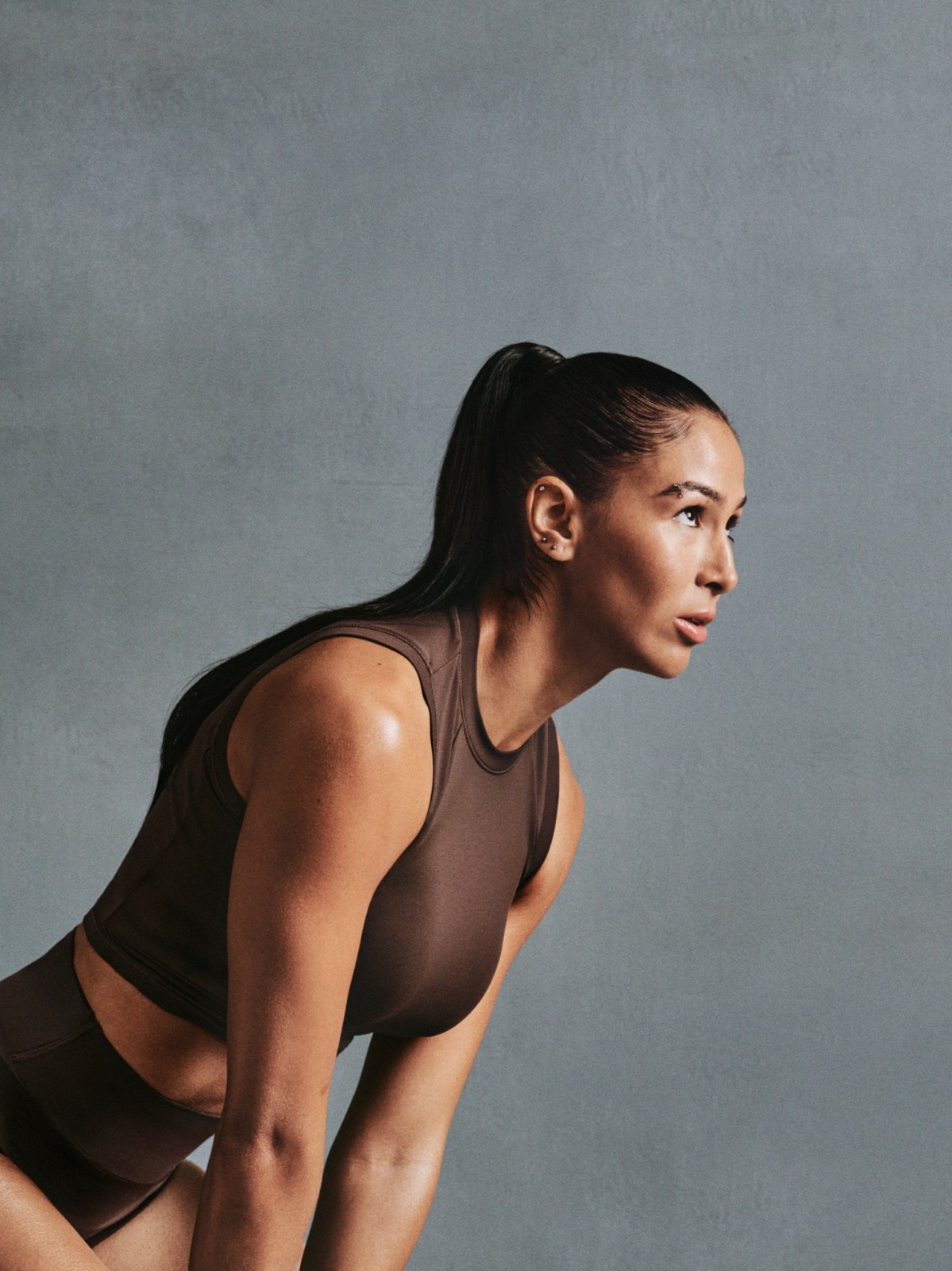 Beatriz Hatz leaning into a training movement in a dark sleeveless set