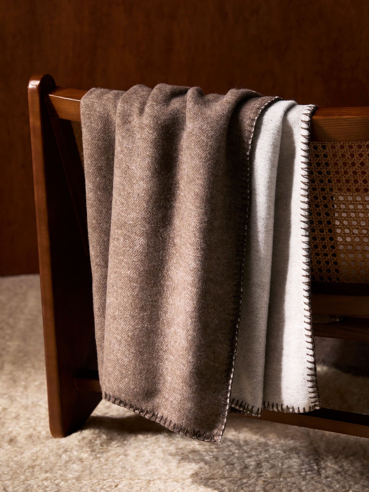 Brown wool throw draped over a cane chair