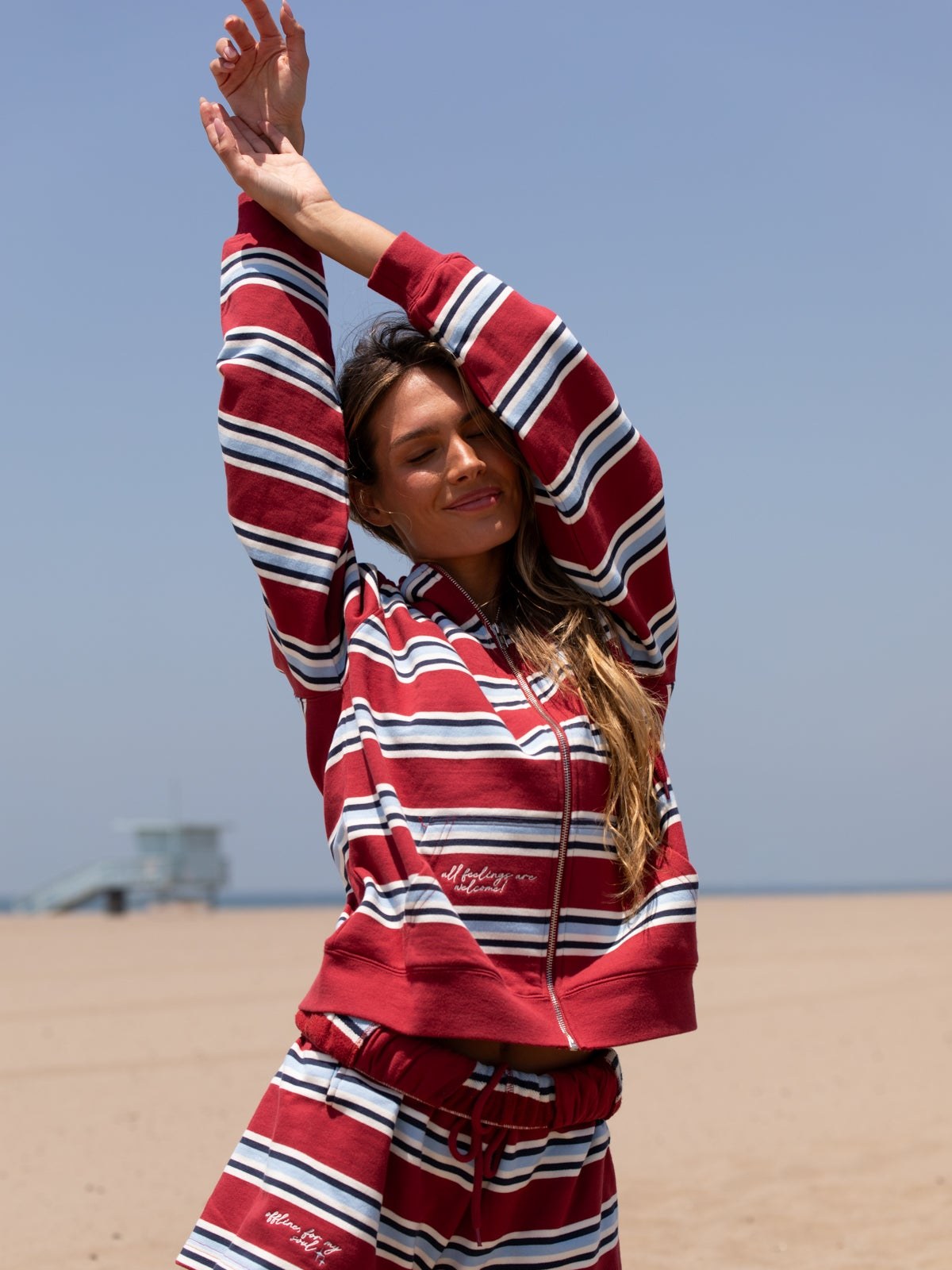 Model in a red striped Mayfair set on a beach