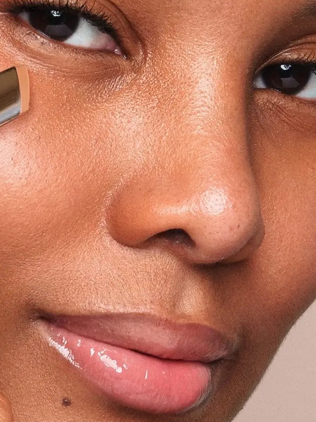 Model with a luminous makeup look in a close-up studio portrait