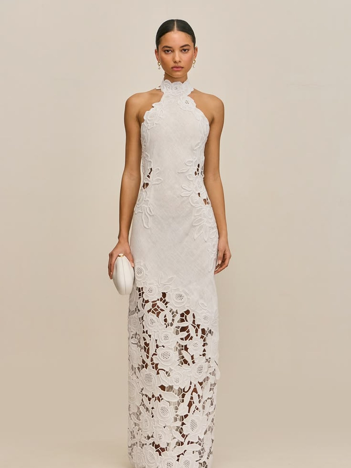 Model in a white halter column gown with lace detail