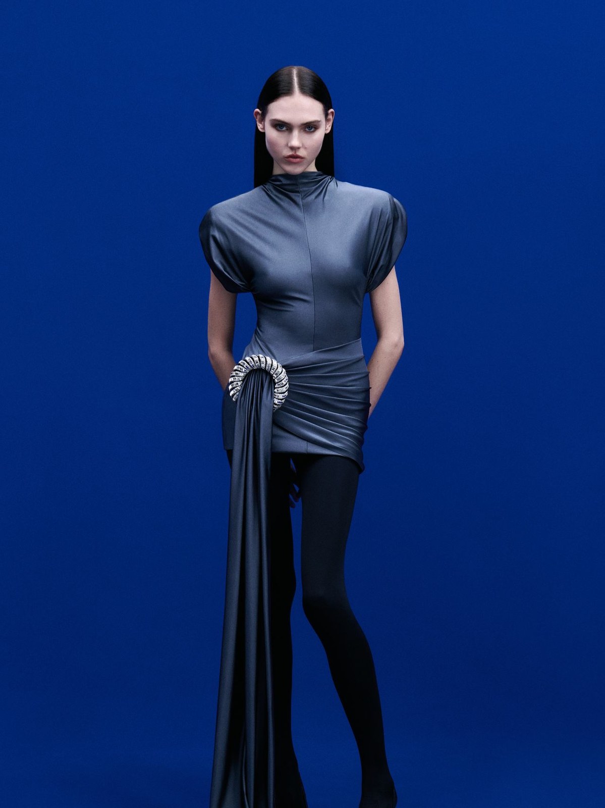 Runway model in a gray sculpted short dress