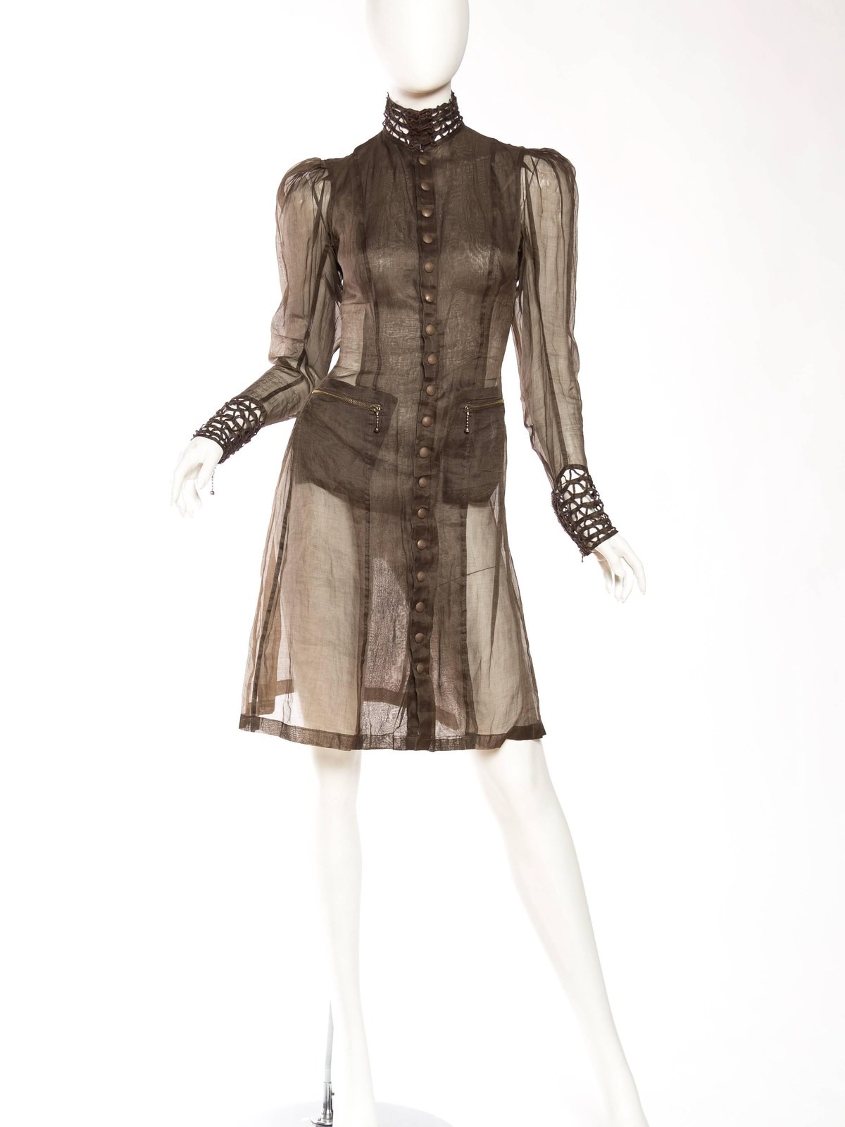 Sheer brown button front dress with laced cuffs and high collar on a mannequin