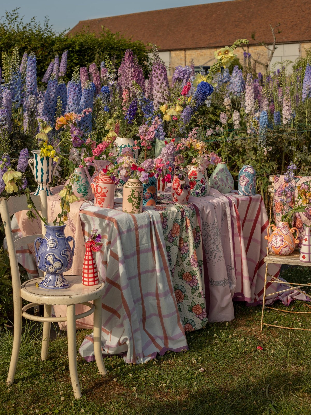 Colorful Vaisselle table setting among flowers in a garden