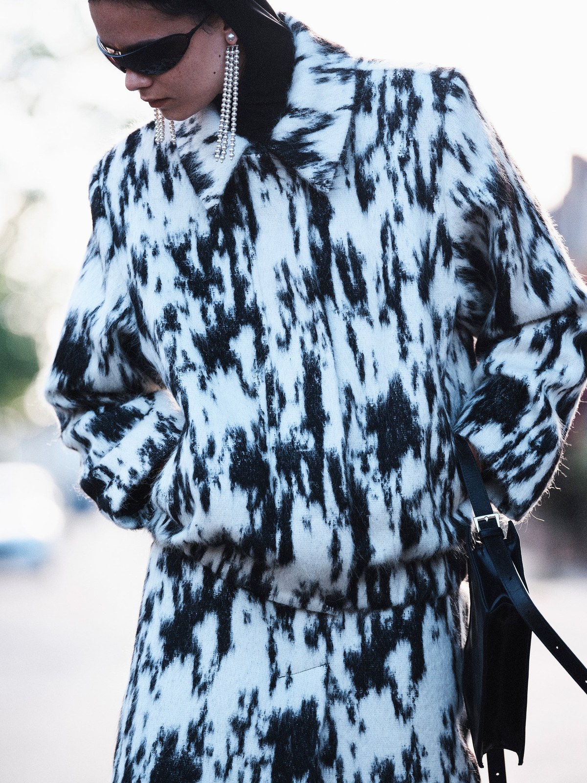 Model in a black and white patterned Beaufille look outdoors for FW26