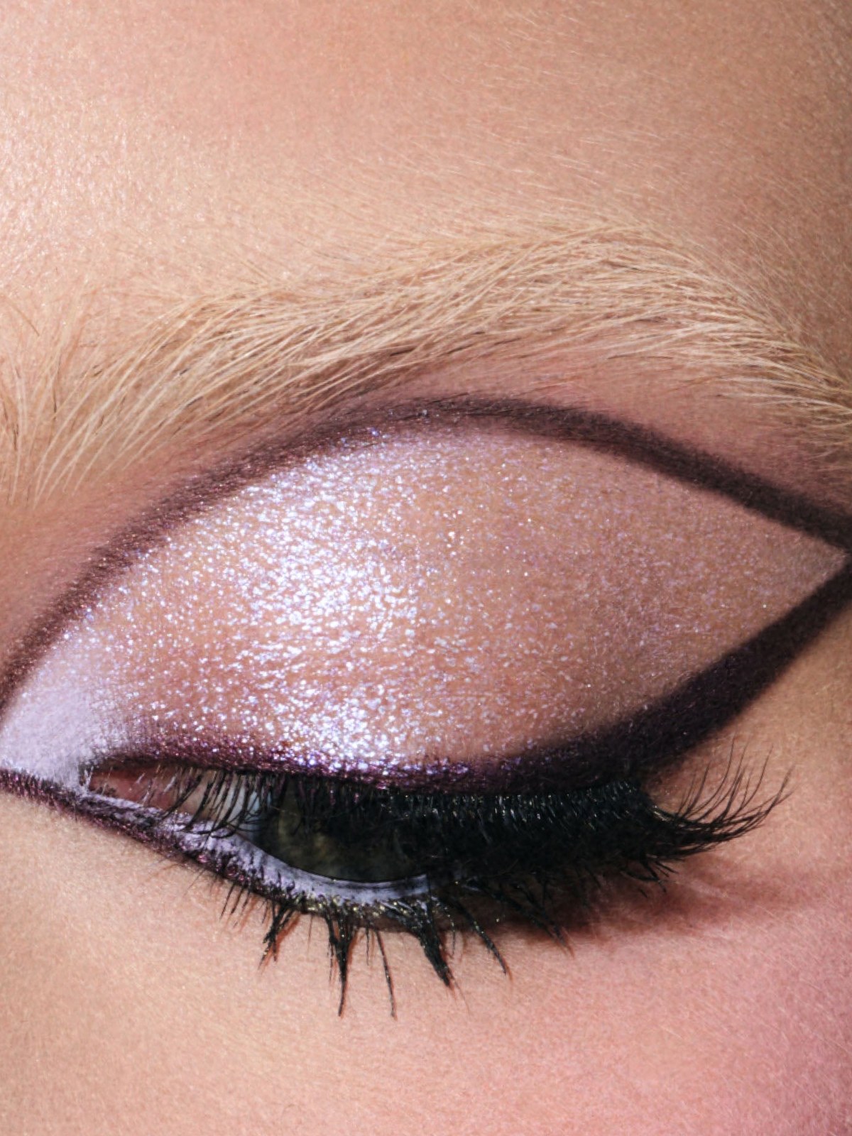 Close-up of a graphic lilac eyeliner look