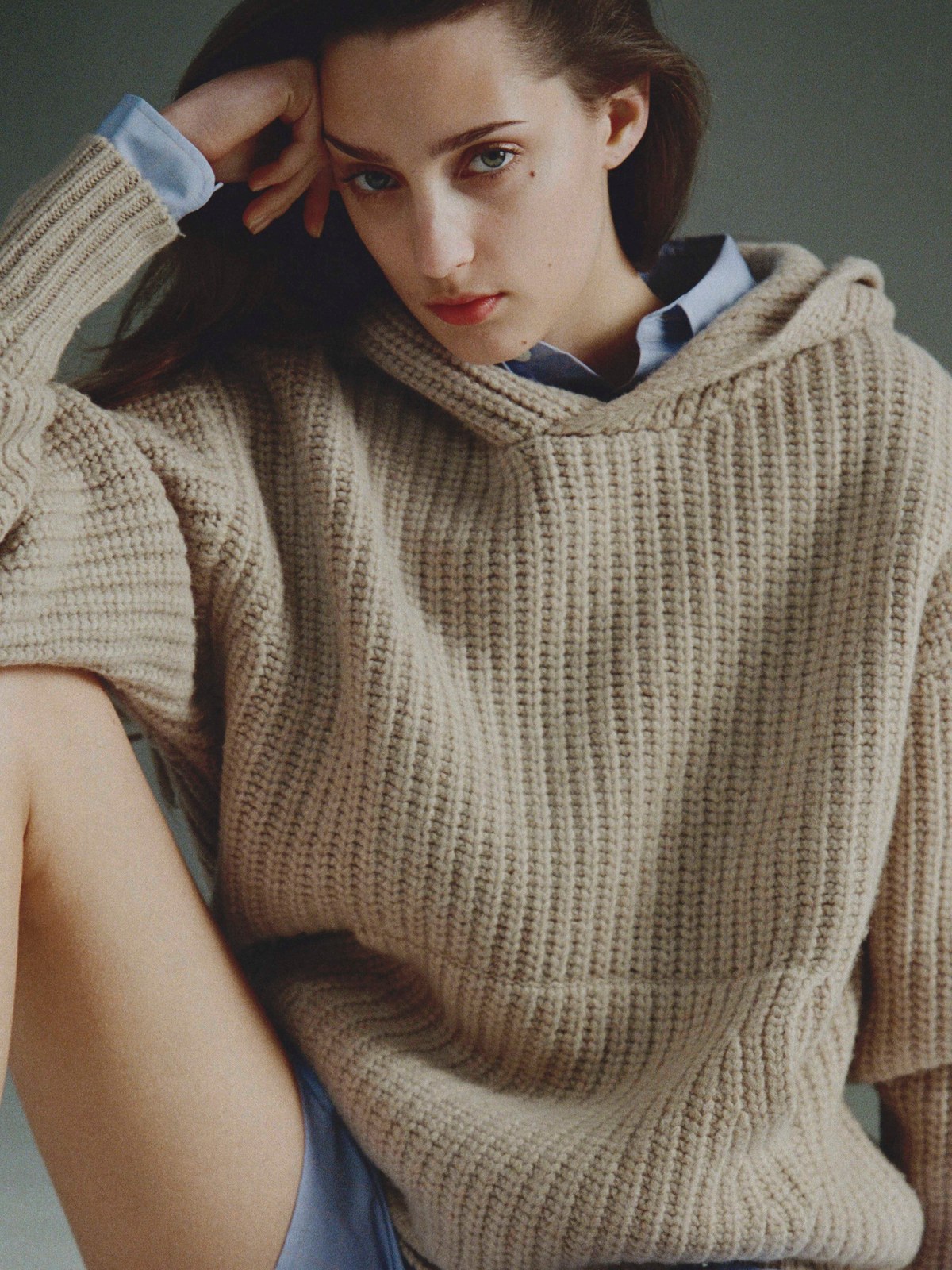 Model in a chunky oatmeal knit and blue shorts