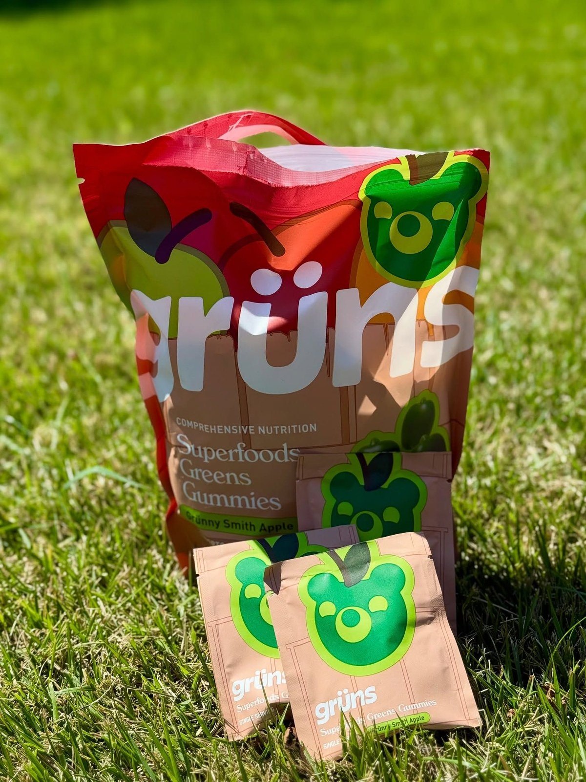 Grünny Smith Apple flavor Grüns gummies bag standing in grass