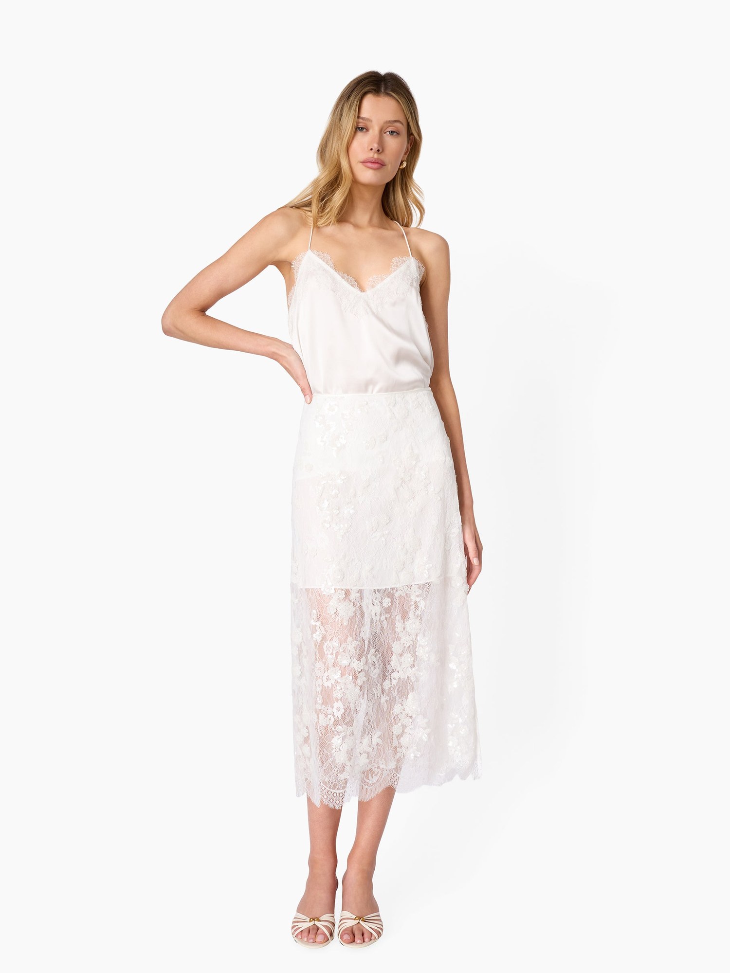 Full length model in a white silk cami and lace midi skirt