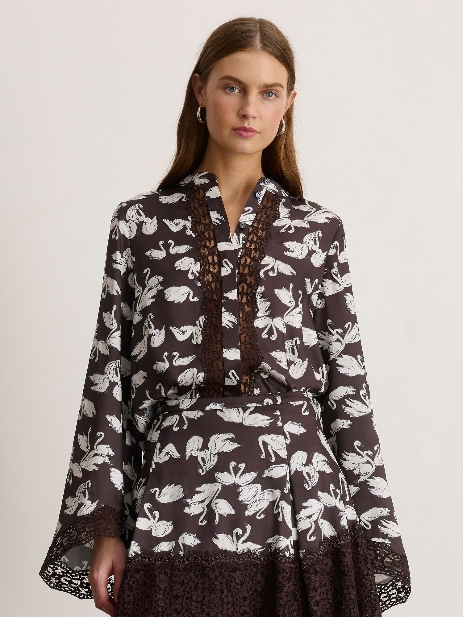 Model in a swan print blouse with lace trim