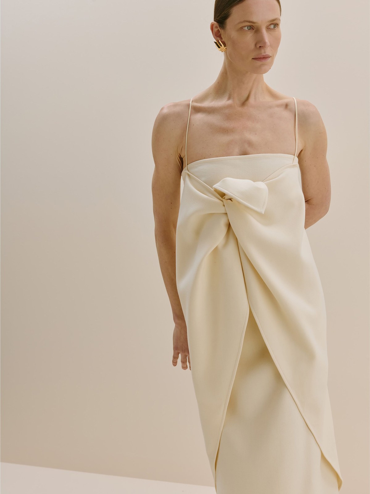 Model in a draped ivory strapless dress for Bevza Fall 2026