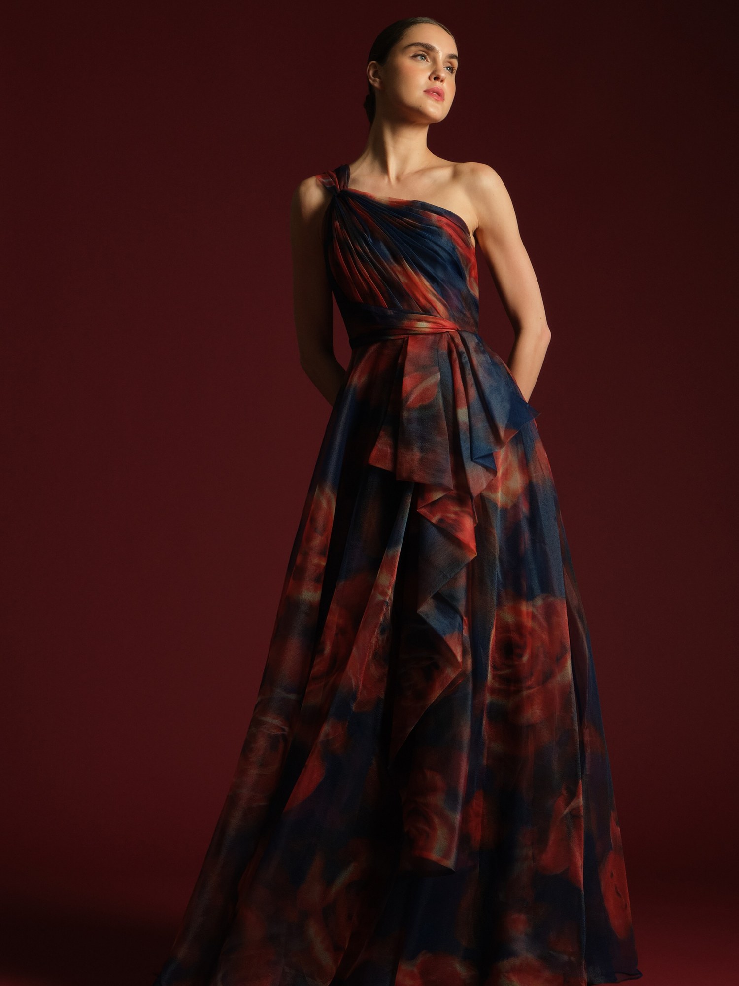 Model in a dark floral organza strapless gown