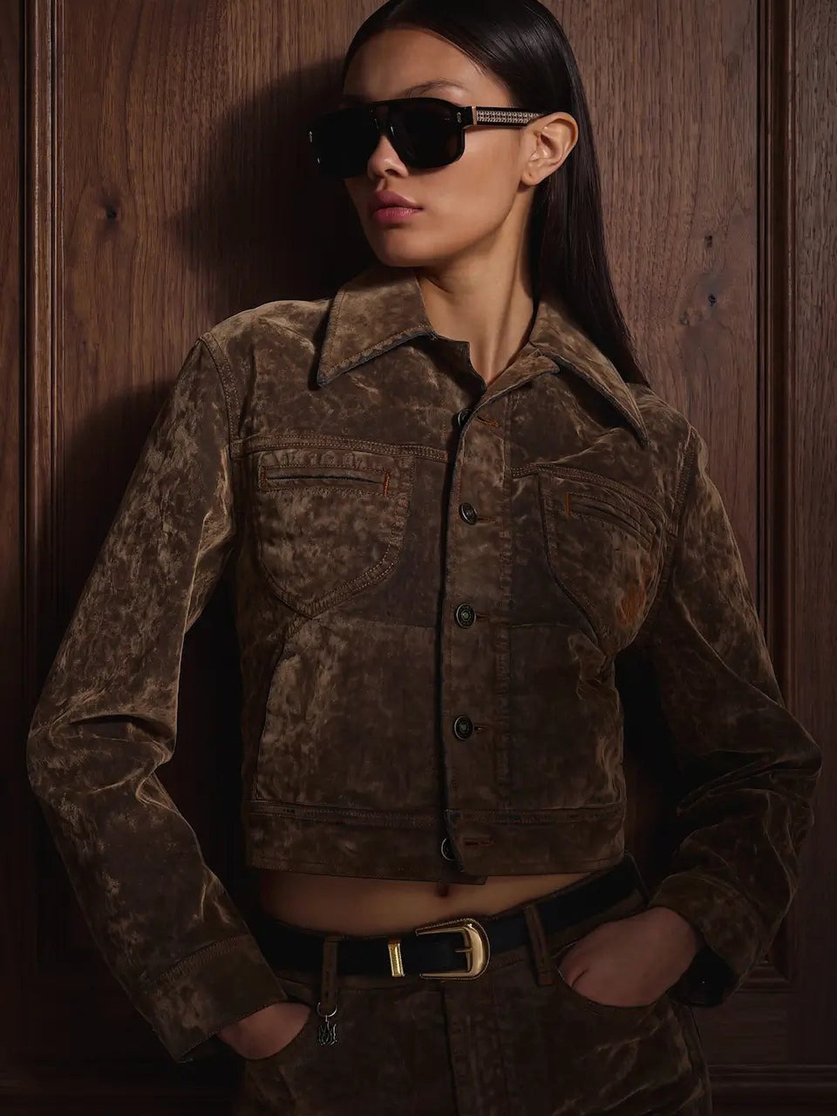 Woman in sunglasses and a brown printed suede jacket