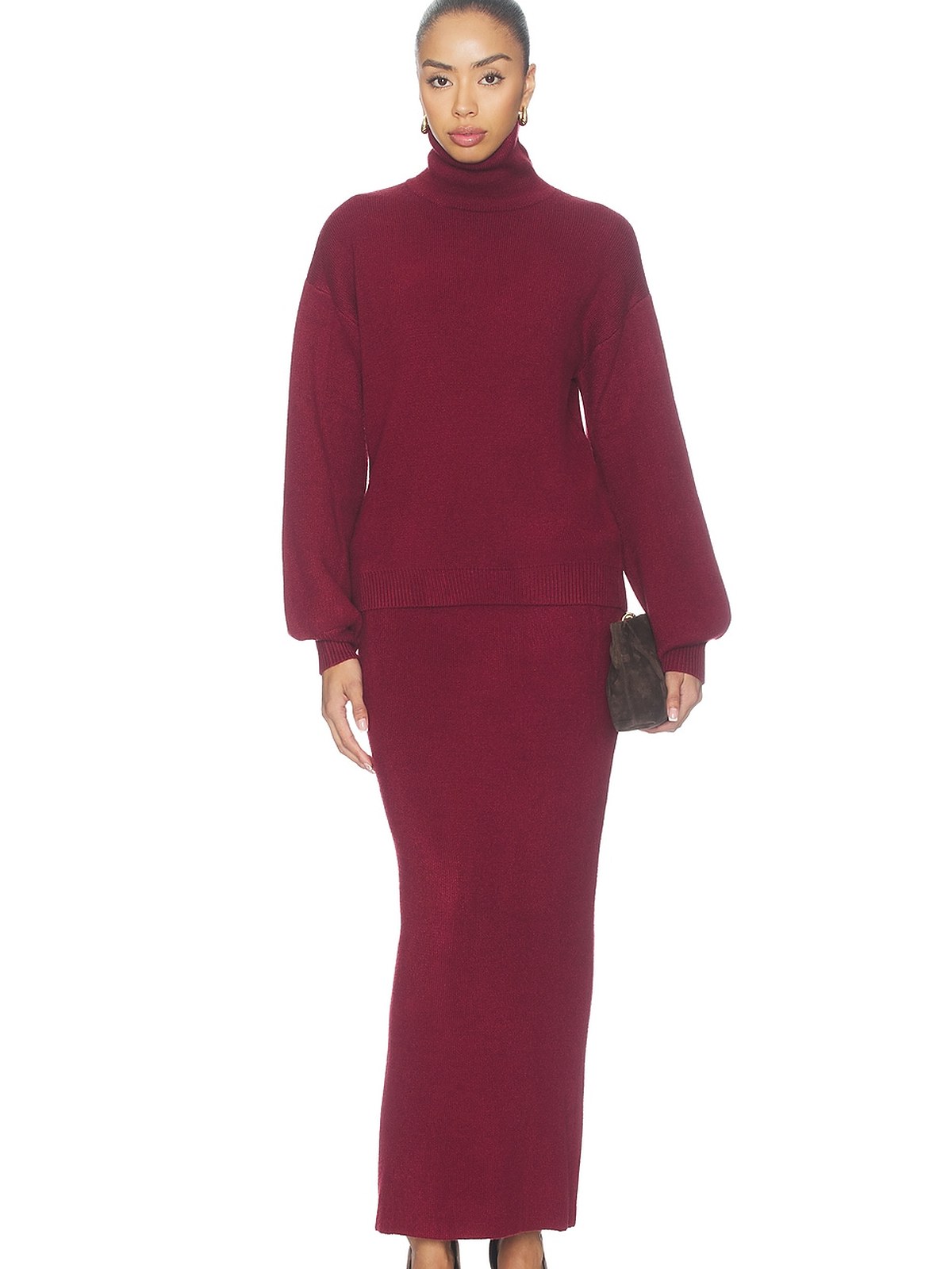 Model in a burgundy knit puff sleeve top and maxi skirt set