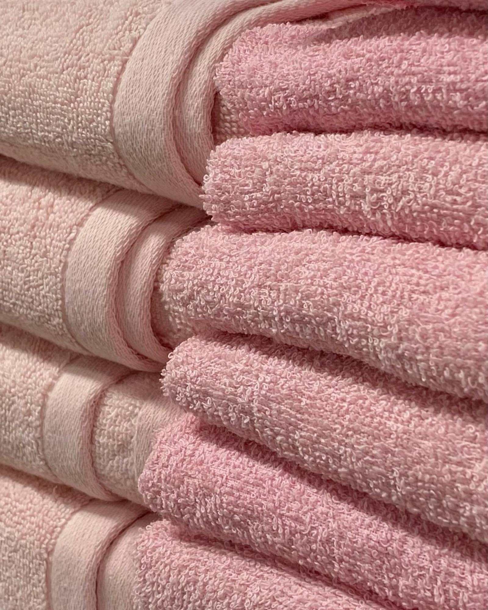 Stack of folded pink terry cloth towels