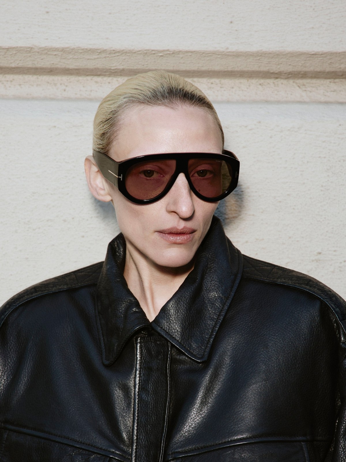 Close-up of model in a black leather jacket and sunglasses