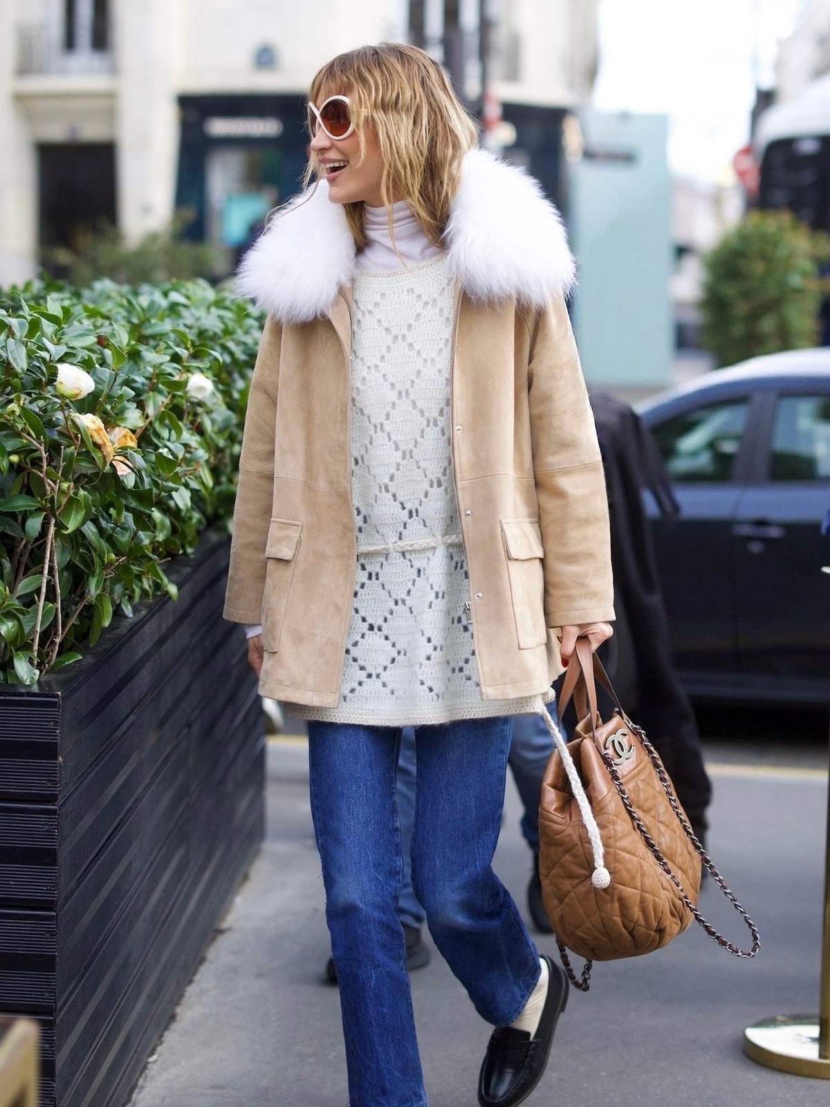 Bella Hadid in a cream suede coat on a city sidewalk