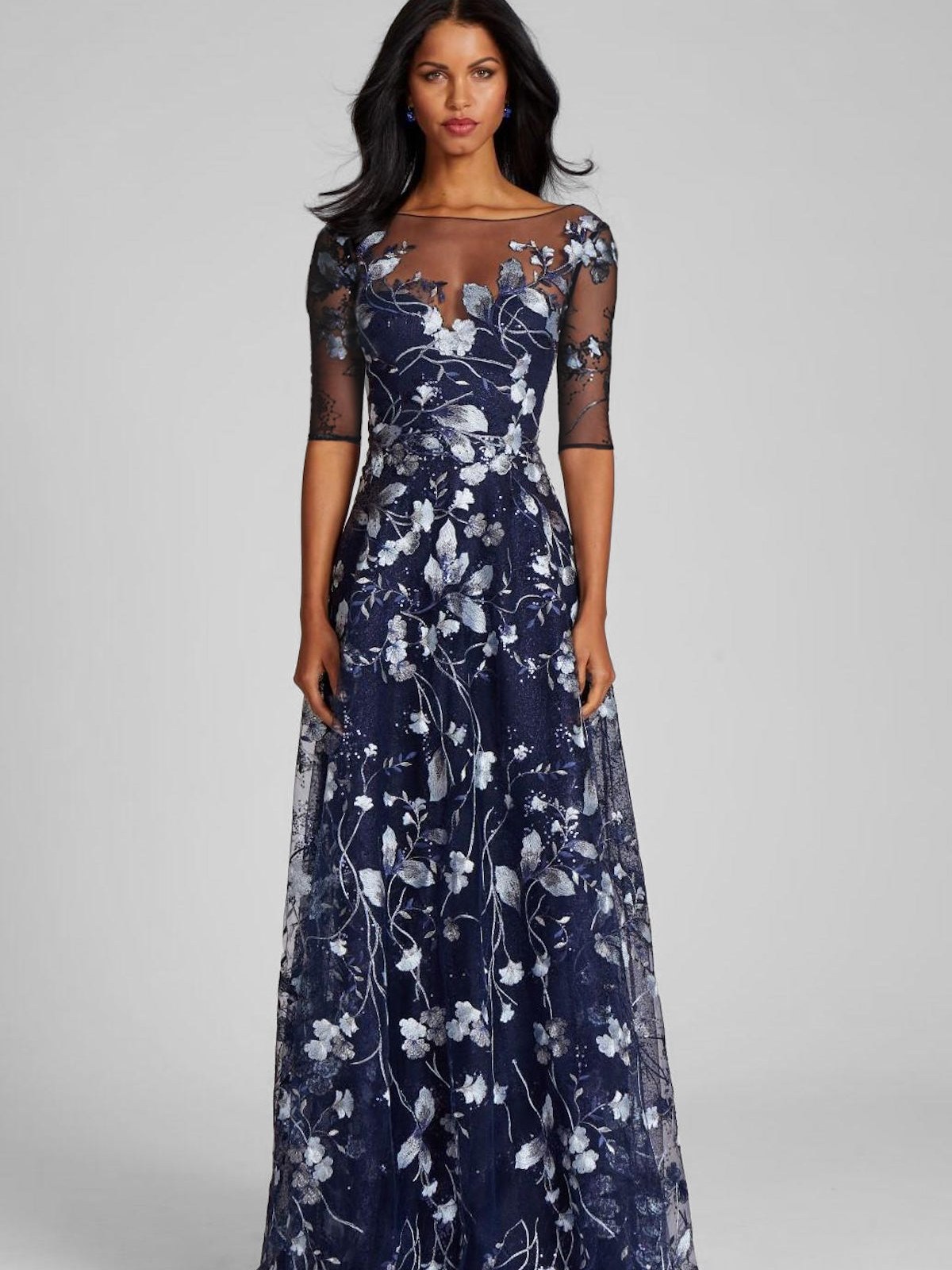 Model in a navy embroidered floral tulle gown