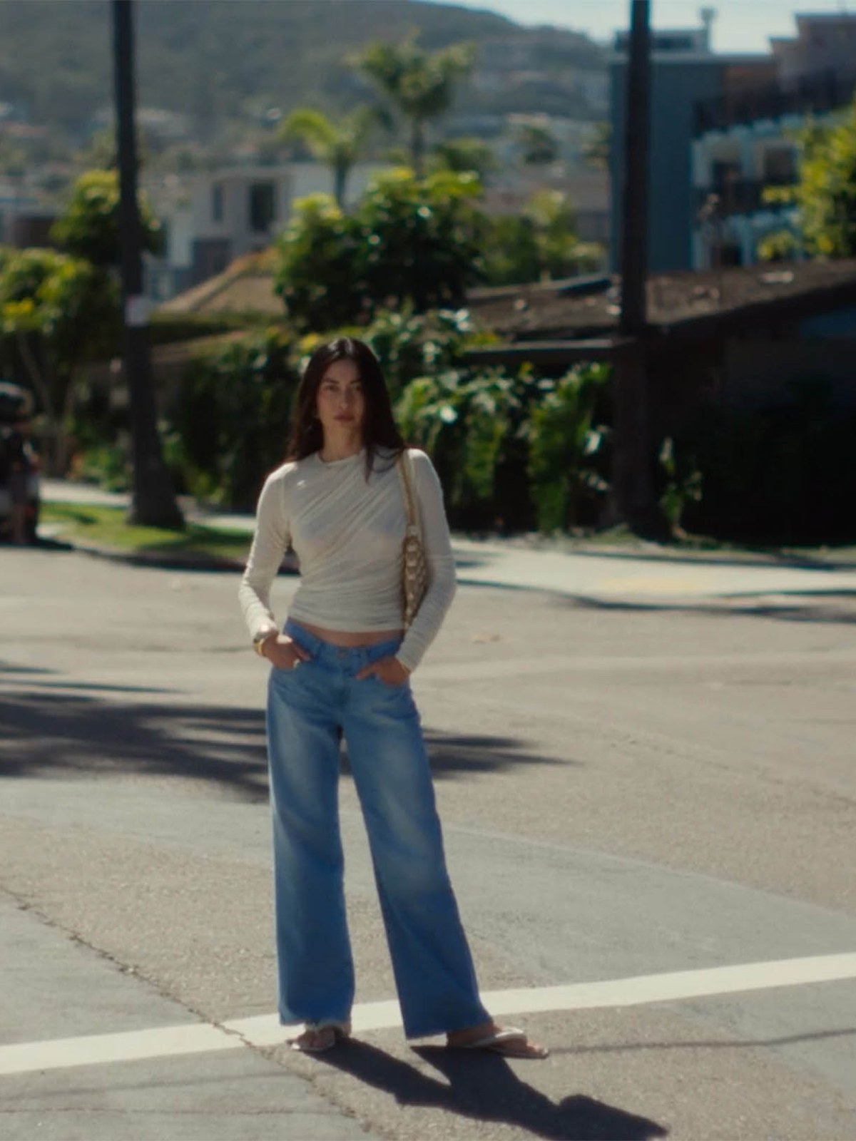 Jessica Mau wearing light wide-leg AG jeans on a Los Angeles street
