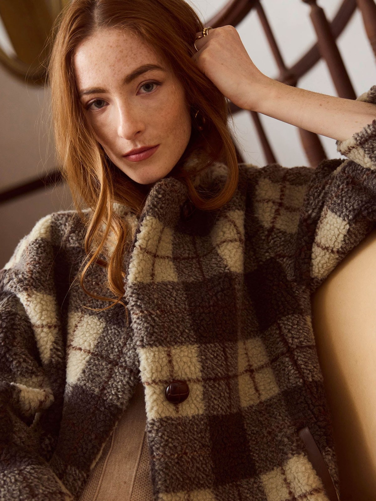 Close portrait of a model in a brown and cream checked Heartloom jacket