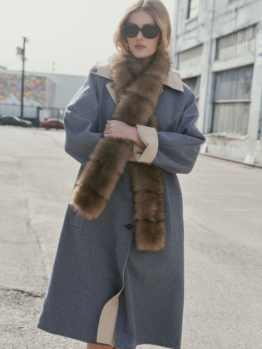 Model in a blue plaid coat on a city street