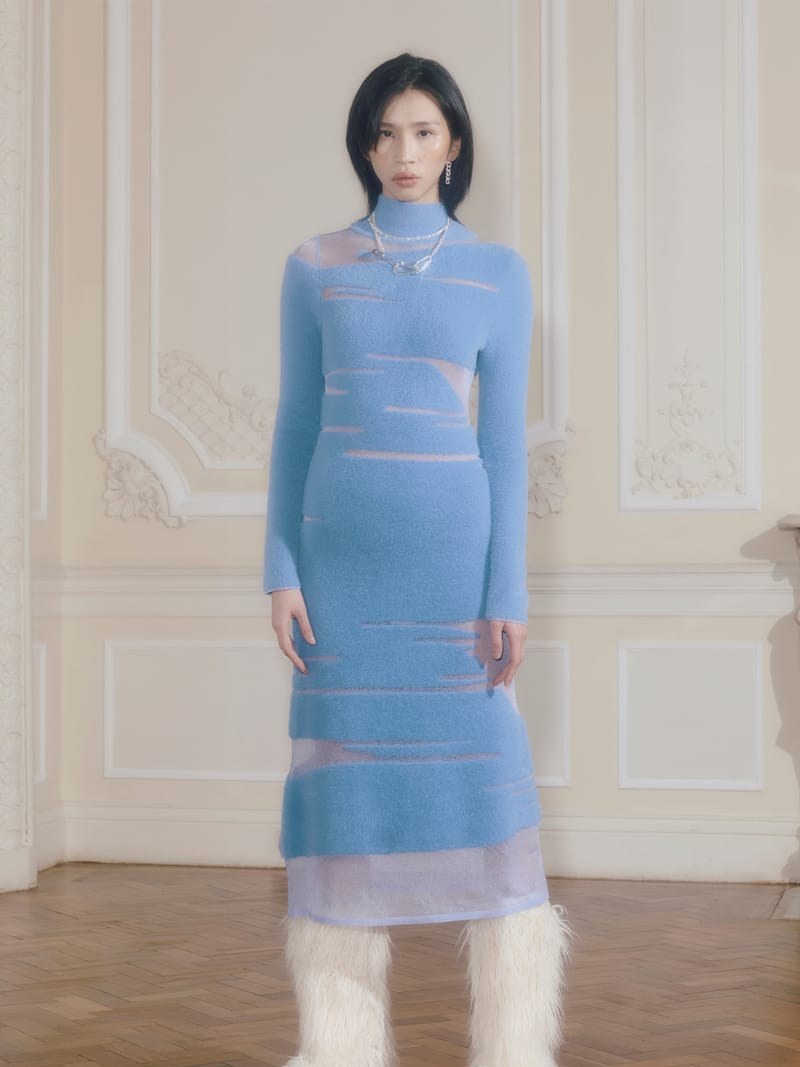 Model in a sky-blue House of Sunny knit dress in an ornate room