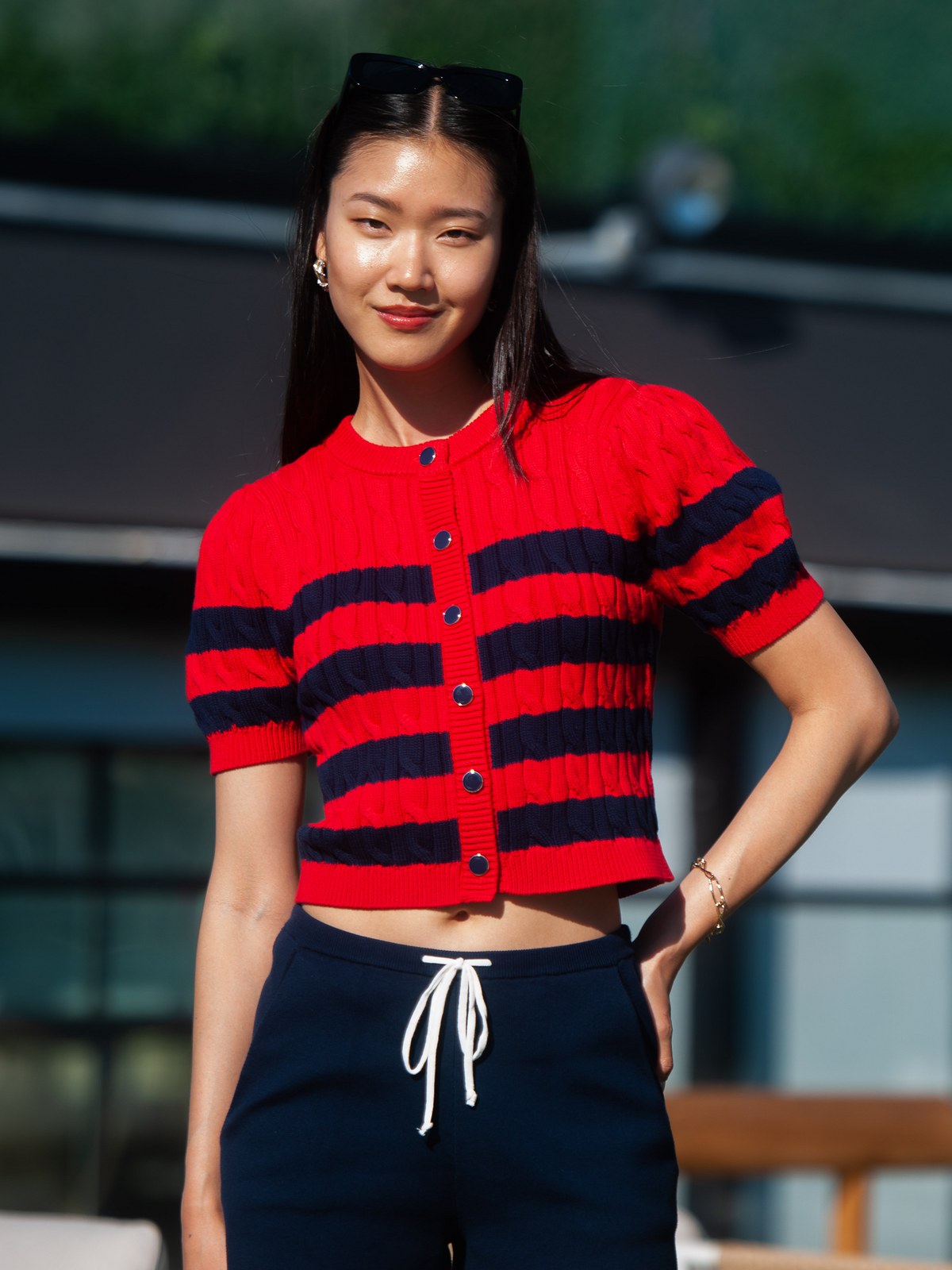 Guest in a red and navy striped knit with matching shorts at a 525 America summer gathering