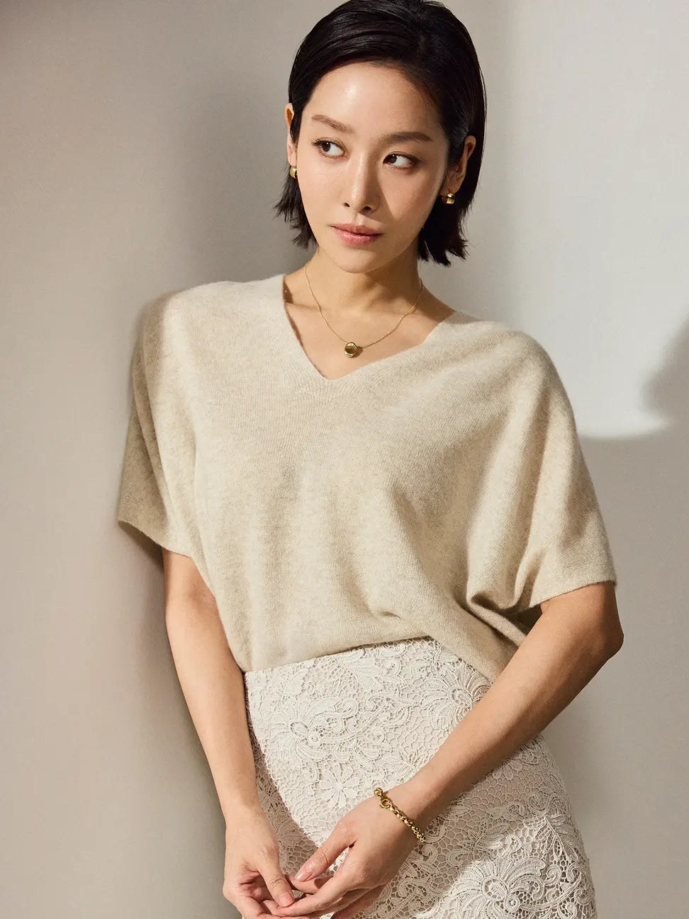 Cha Joo Young in a cream knit top and ivory lace skirt in a neutral studio