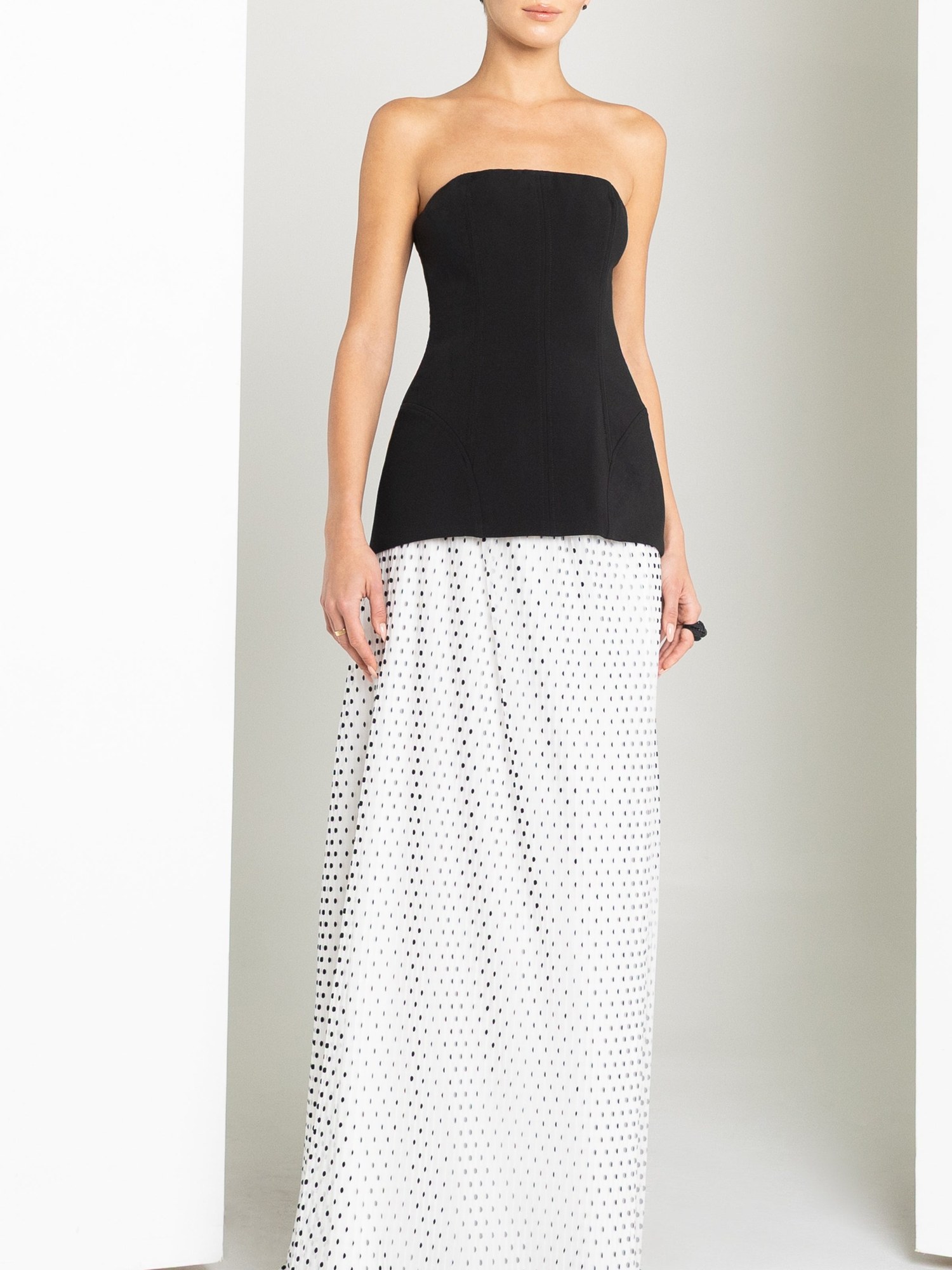 Black strapless top with a white polka dot tulle skirt