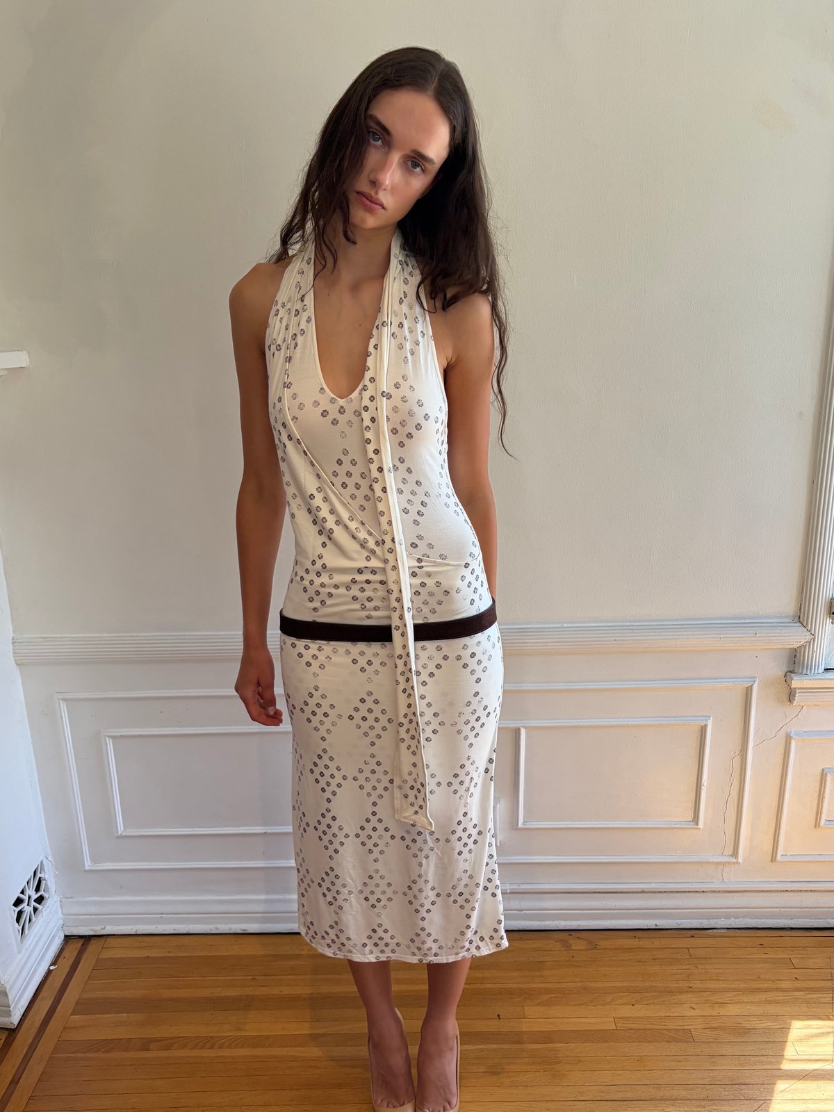 Model wearing an ivory openwork look in a light room with hardwood floors