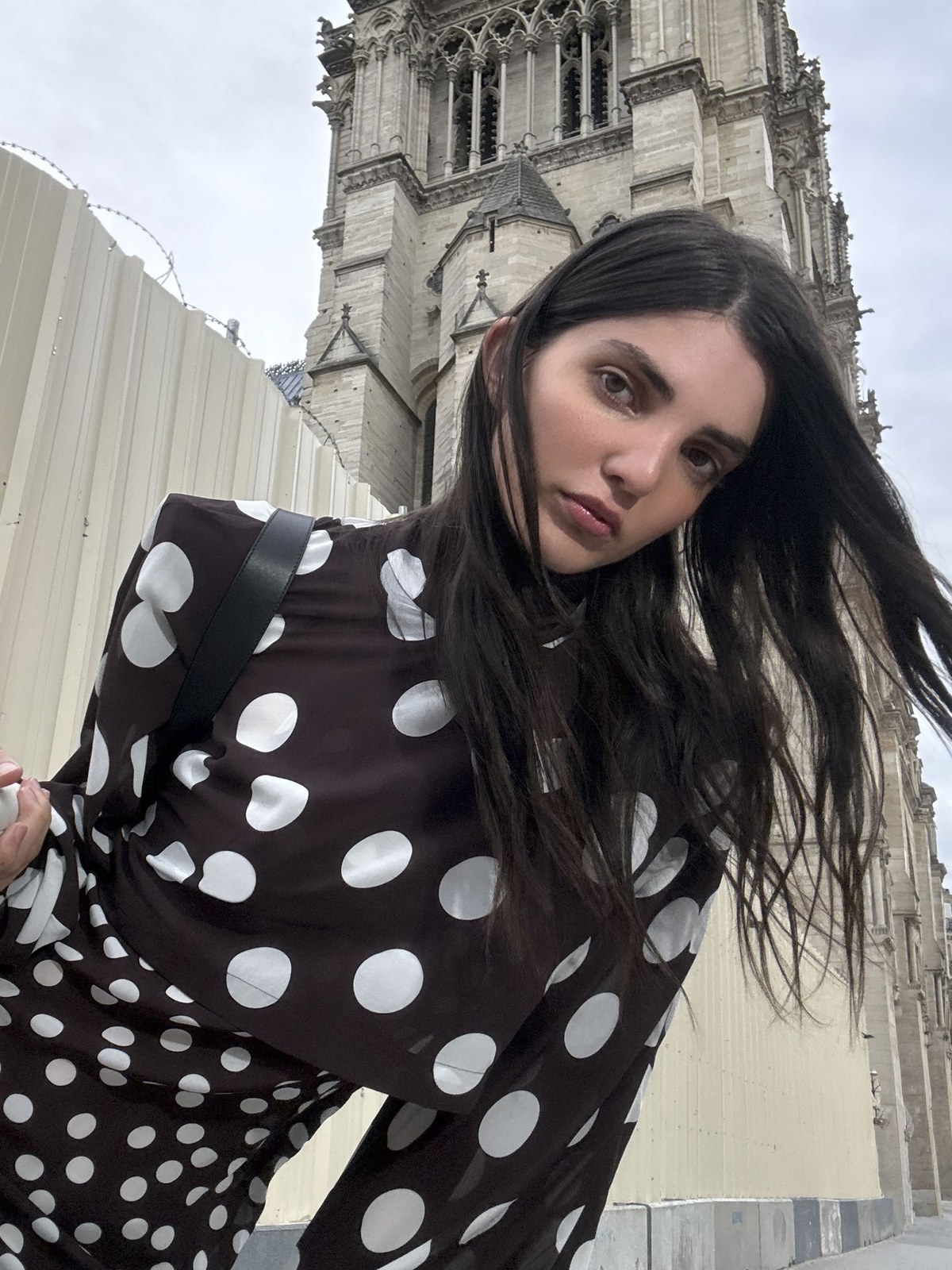 Model in a polka dot outfit near Notre Dame