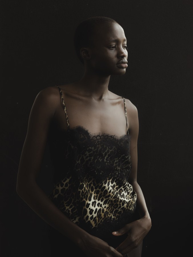 Model in black lace and animal print in a dark studio portrait
