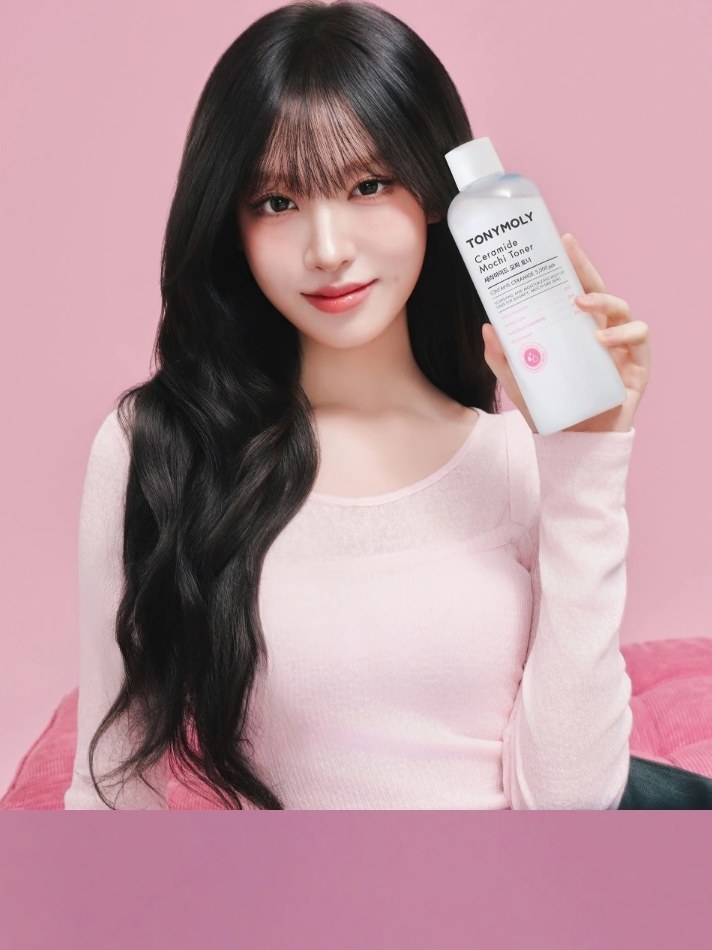 Liz holding Wonder Ceramide Mochi Toner against a pink studio backdrop
