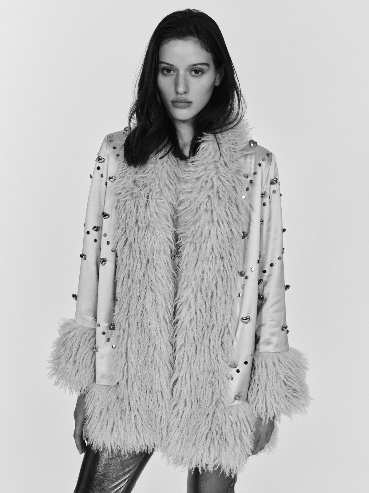 Model in a pale embellished coat from Understated Leather’s Fall 2026 campaign