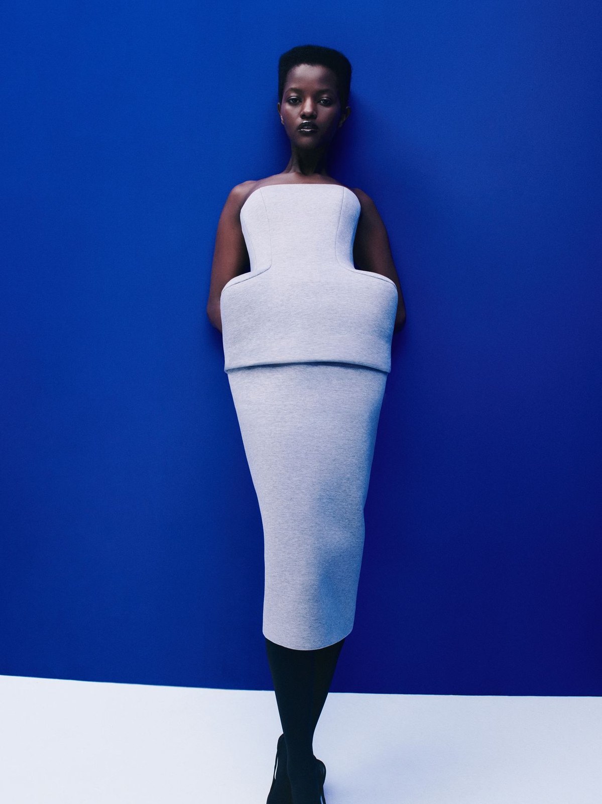 Runway model in a sculptural white dress