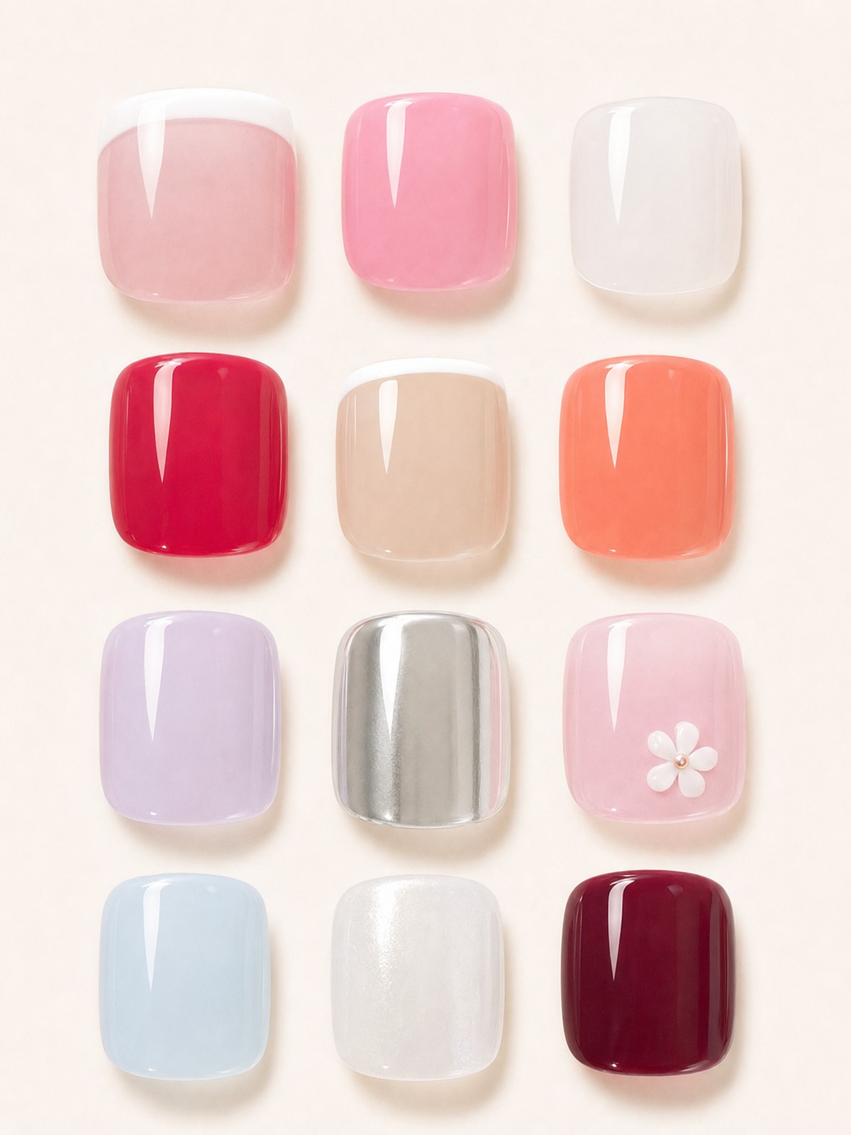Nail trend collage of twelve square press-on toenail tips on a cream card: pink and nude French tips, bubblegum pink, milky white, cherry red, coral, lilac, silver chrome, pale pink with a white flower, powder blue, pearl white and burgundy