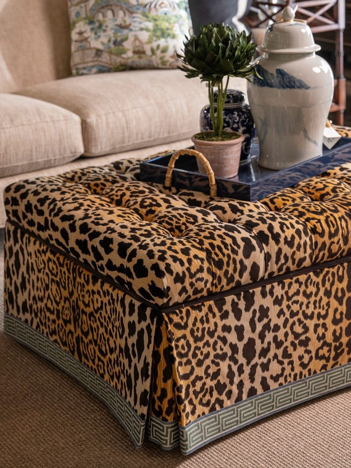 Leopard print skirted ottoman in a living room