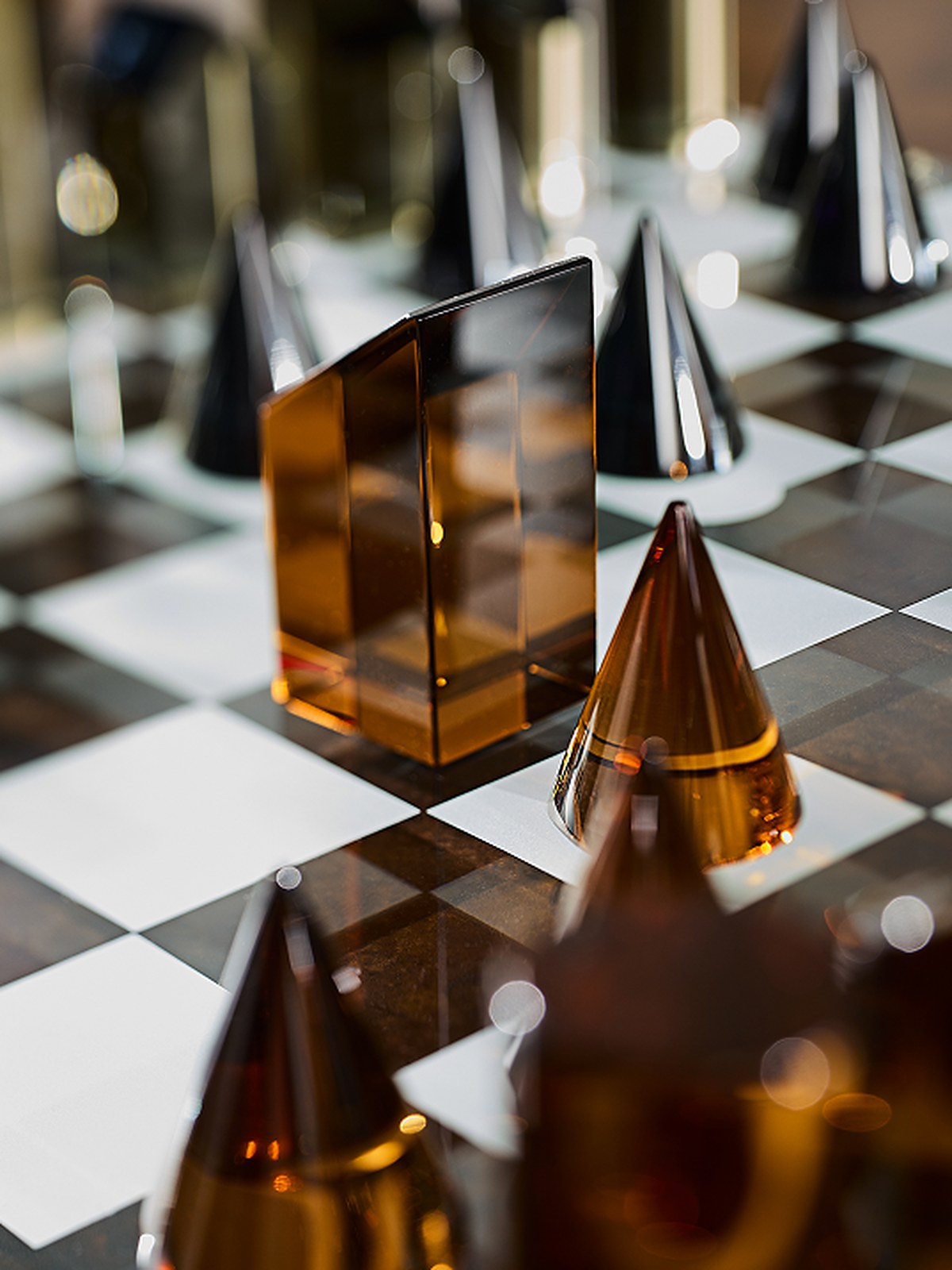 Glass chess set on a checkerboard