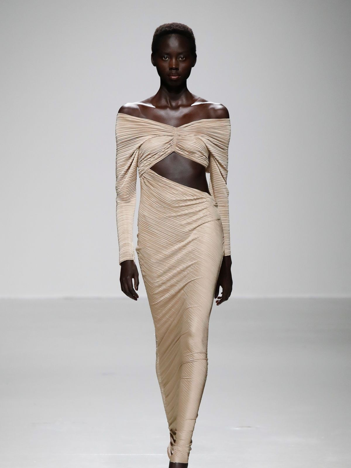 Model in an ivory off-shoulder Atlein gown with a draped cutout bodice