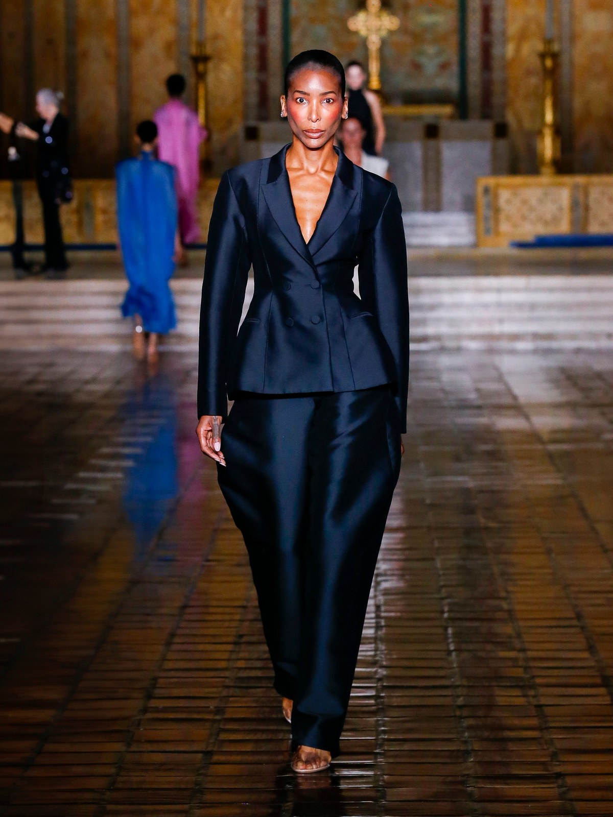 A model wears a black tailored look on the Spring Summer 2026 runway.