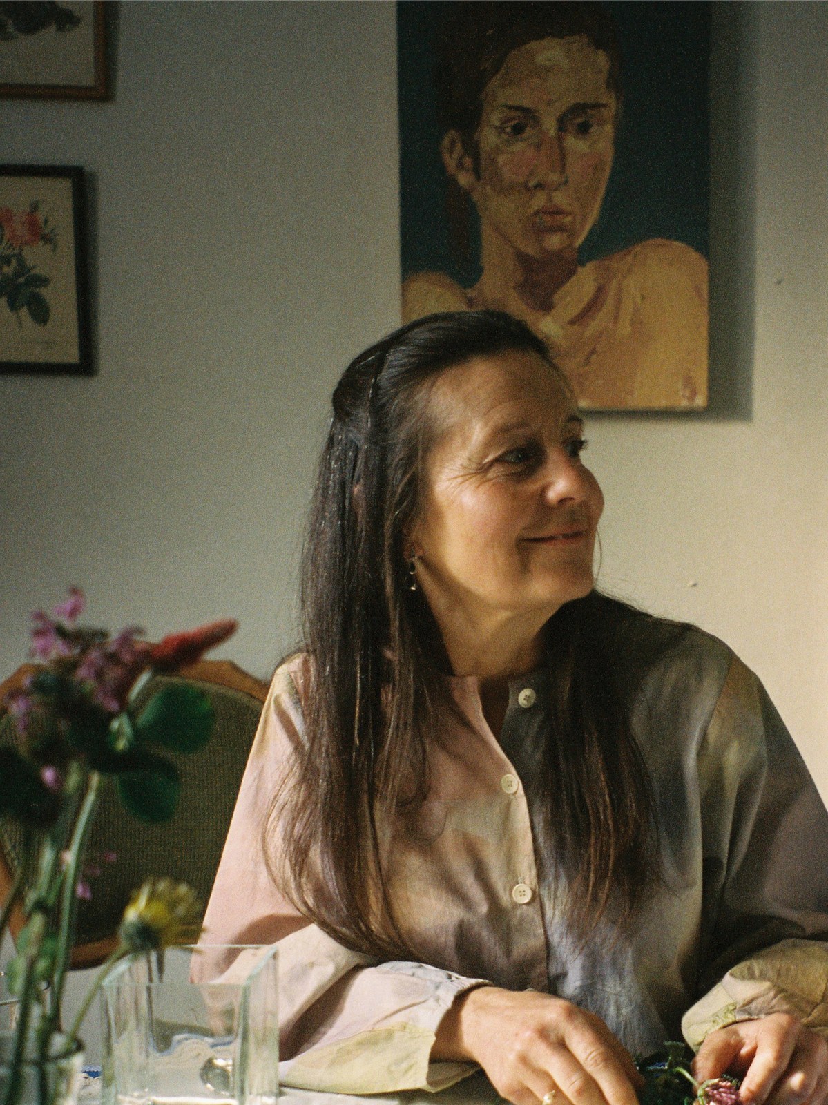 A woman arranging flowers at home for the SALA photojournal