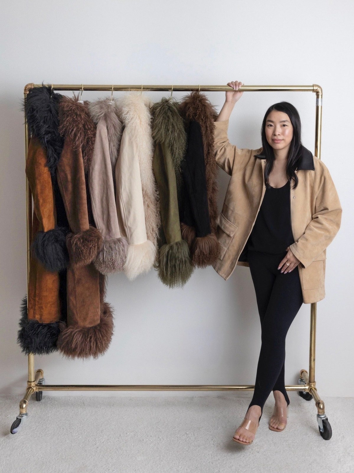Susanna Chow beside a rack of colorful shearling-trim coats