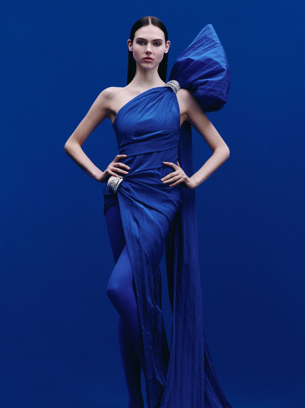 Runway model in an asymmetric blue gown