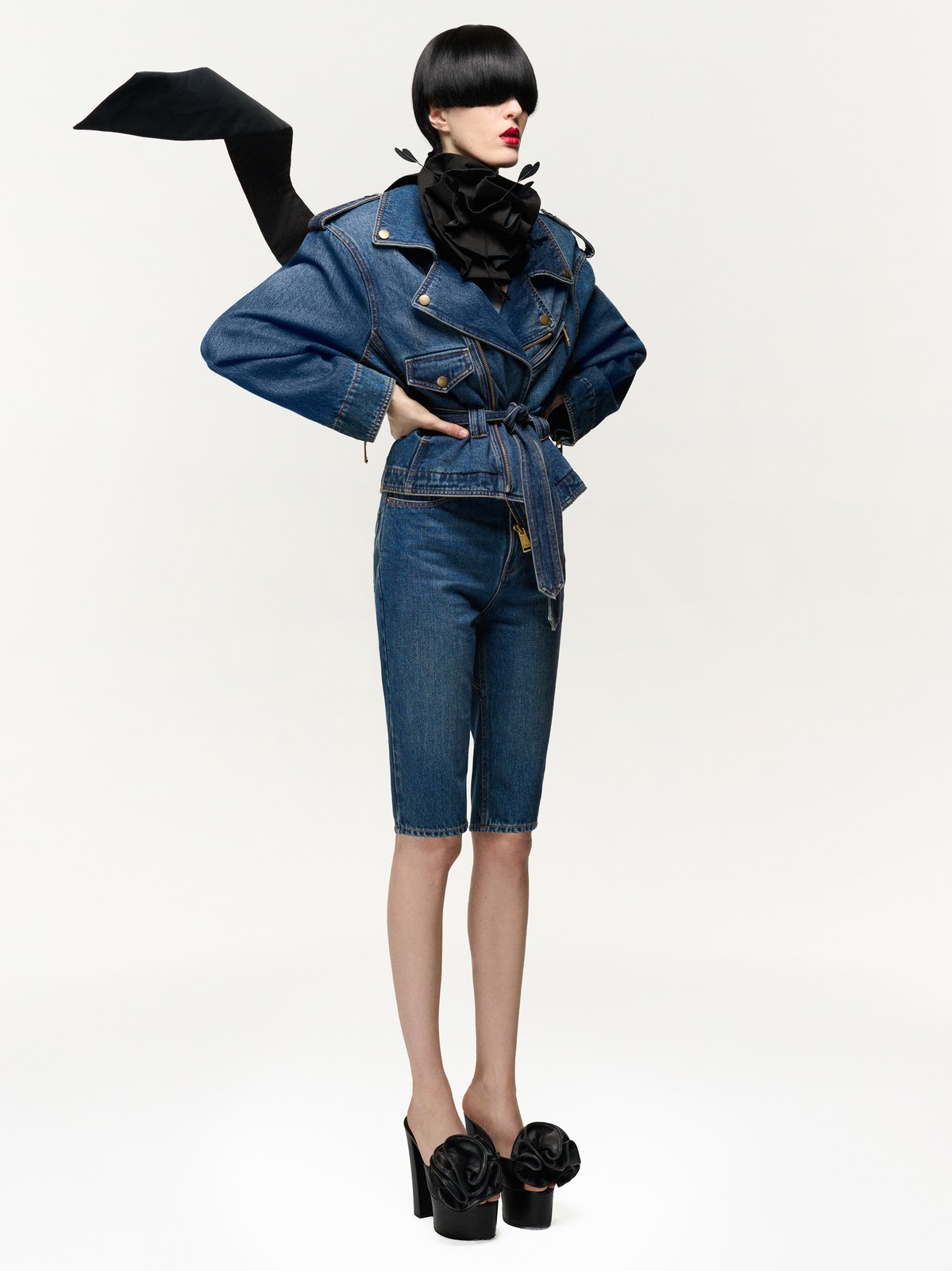 Model wearing a blue AREA denim jacket and knee-length denim skirt