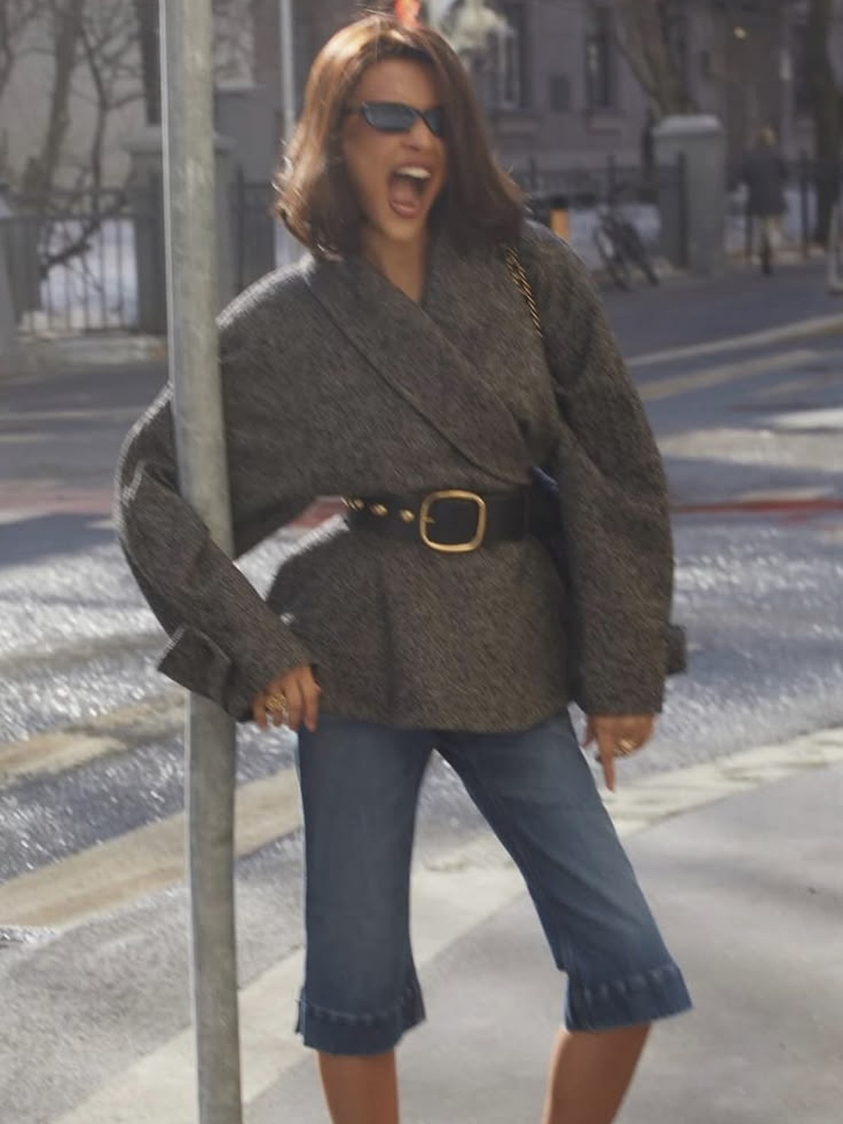 Woman in a cropped jacket and capri jeans with heels on the street