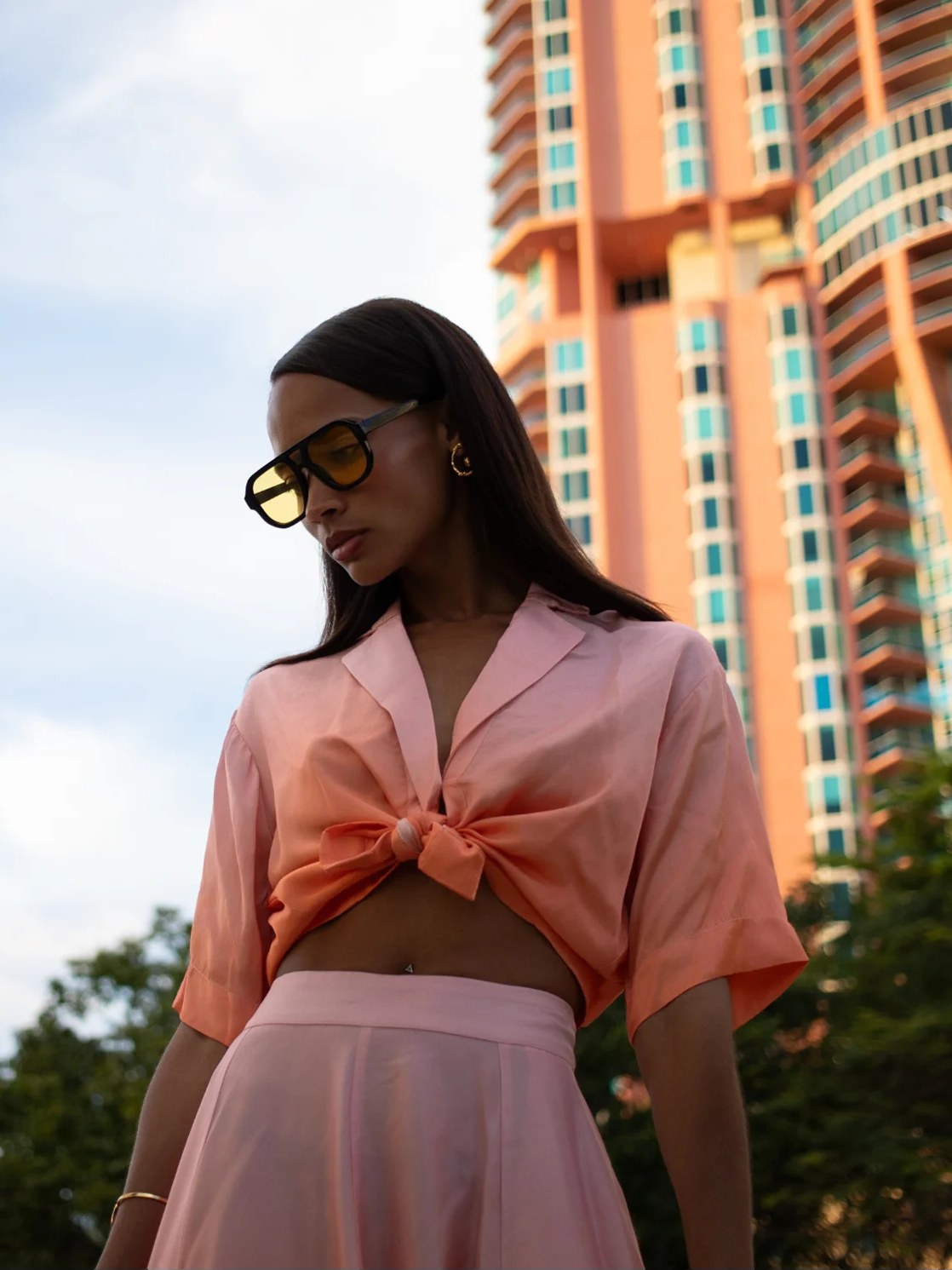 Model in a pink set on a Miami city street