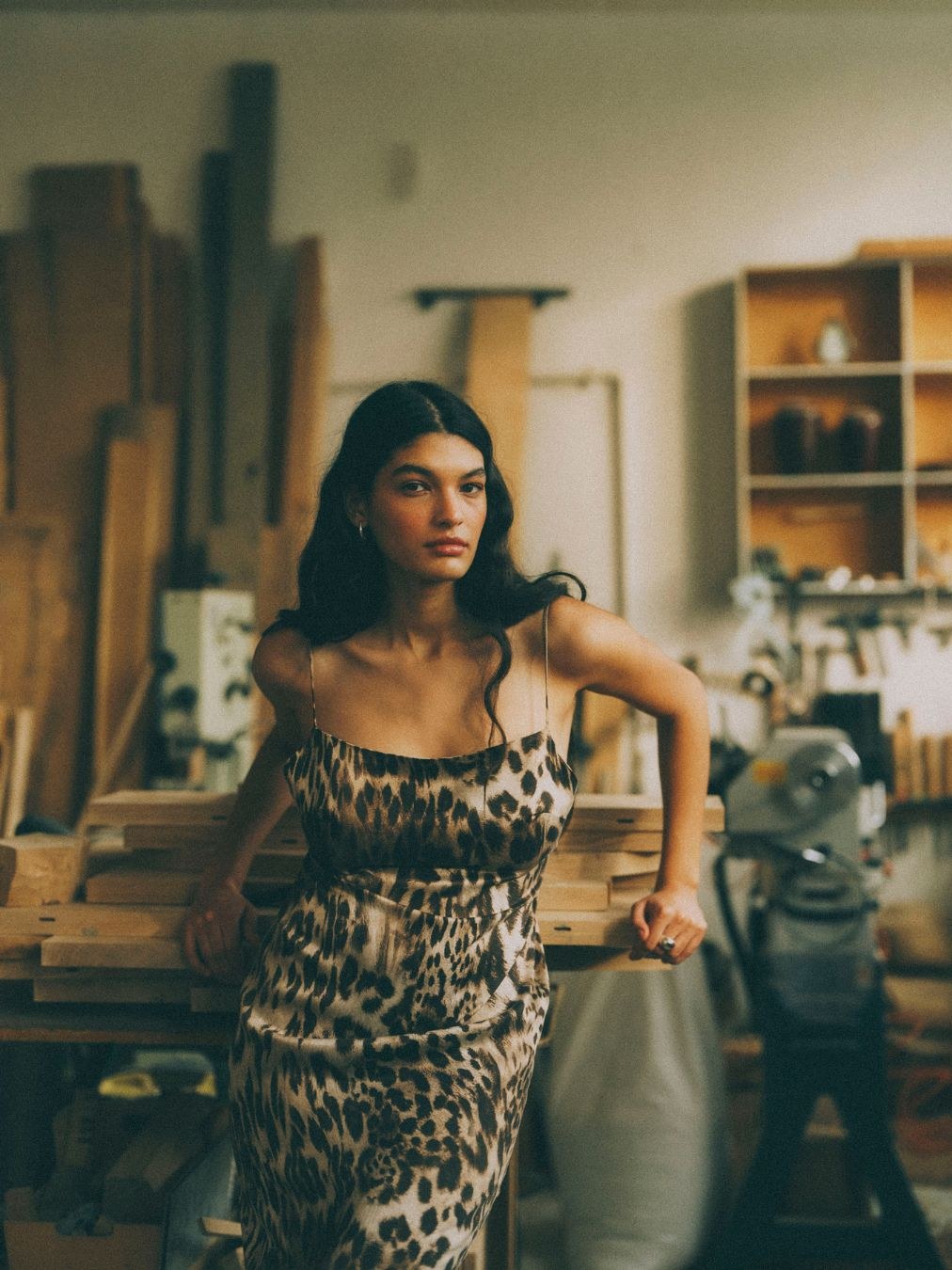 Model in a leopard-print dress in the art studio