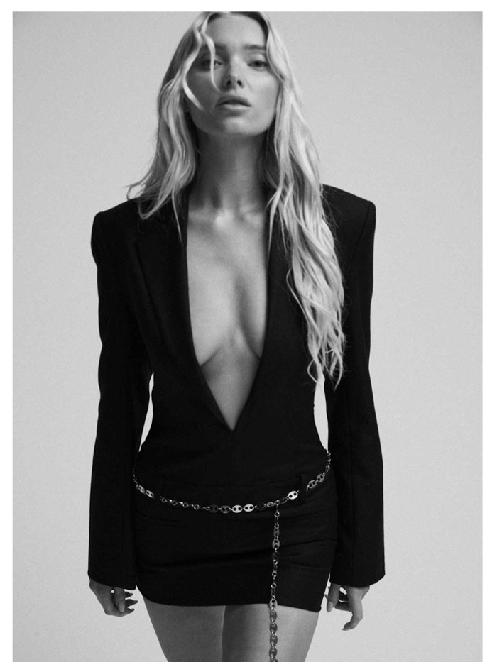 Elsa Hosk in a dark tailored Aya Muse look against a pale studio background